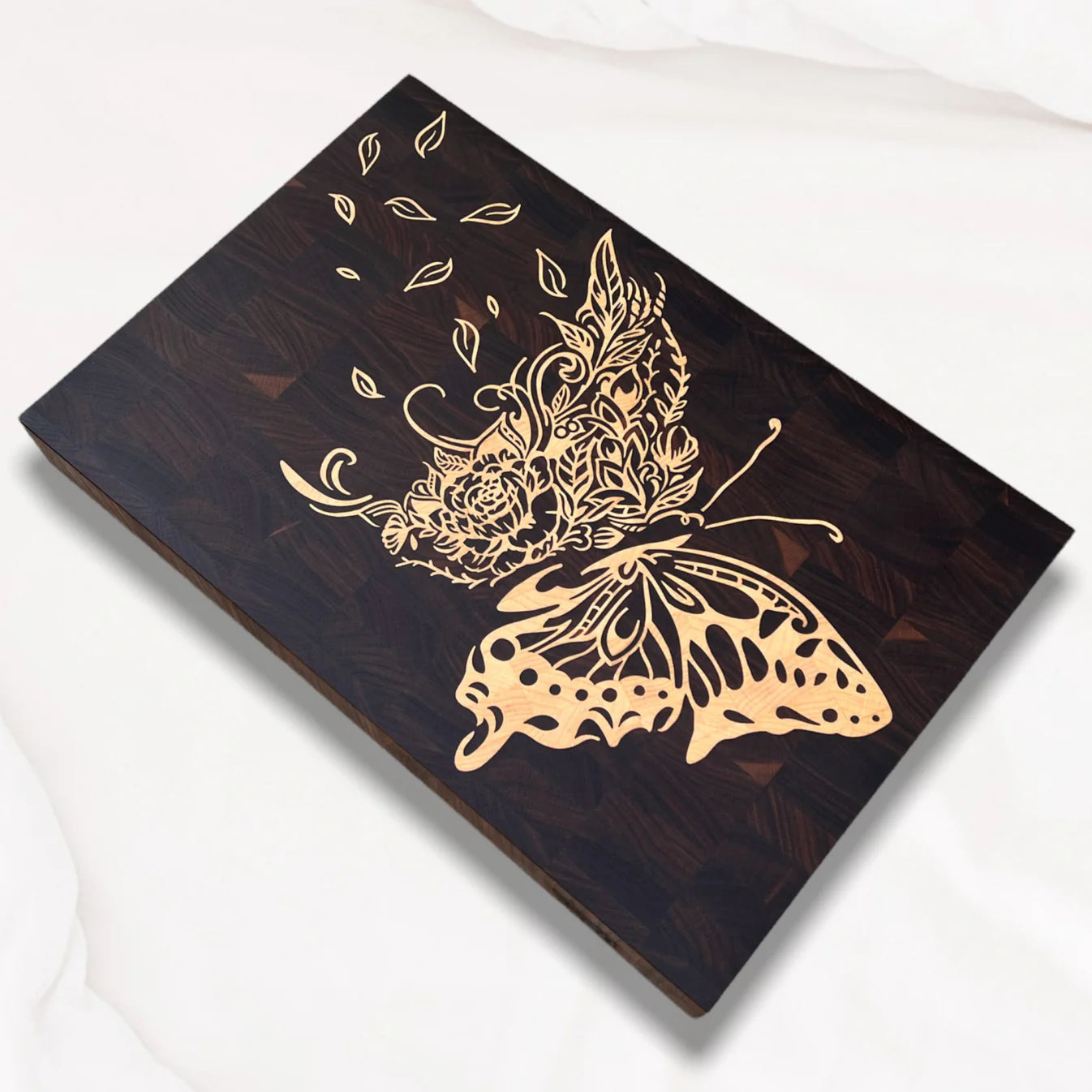 Alternative side view of maple inlay of a butterfly design on a walnut board