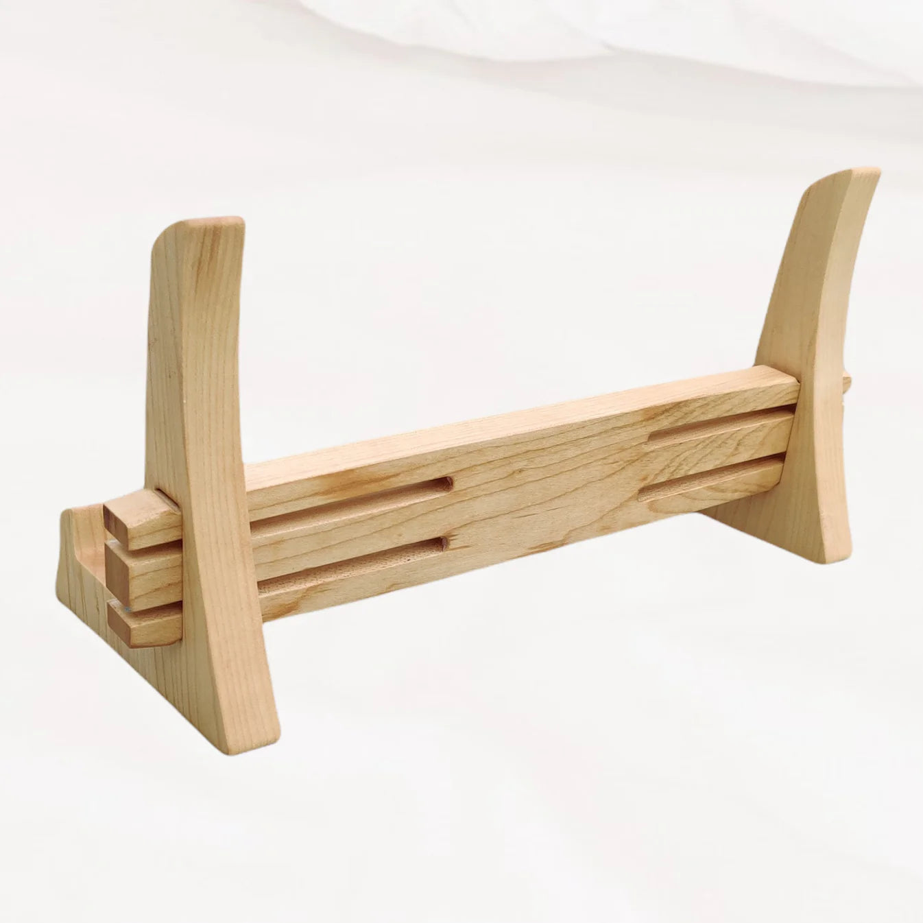 Wooden carving board stand with horizontal bars on a white background