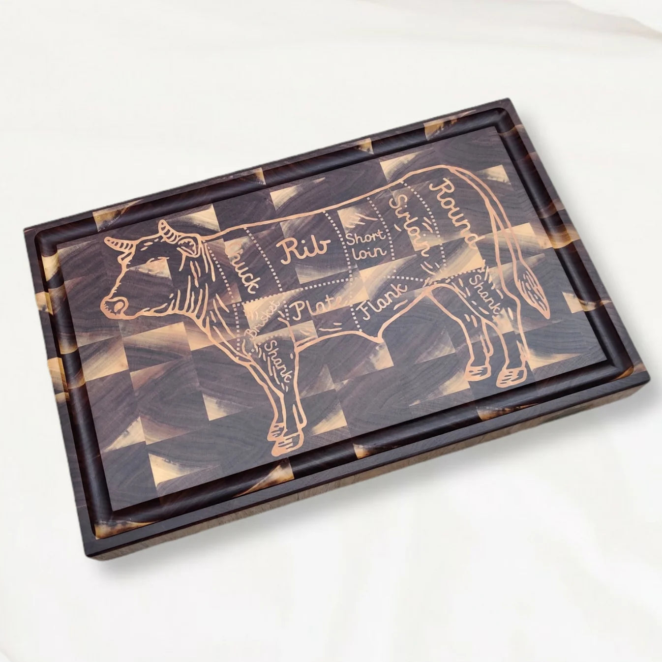 Wooden cutting board with cow cut layout on a white background
