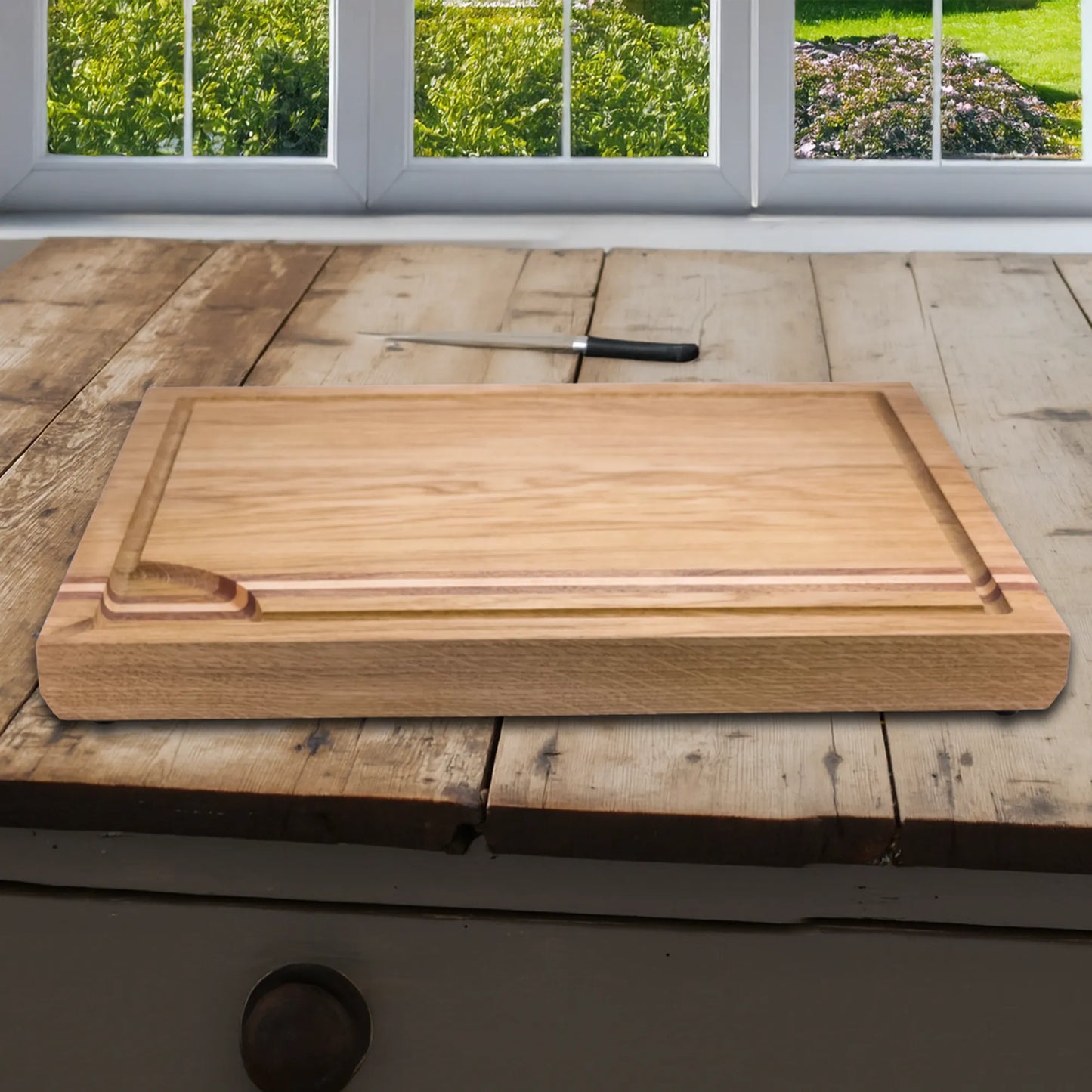 A old fashioned wooden surface with a chopping board with handles.