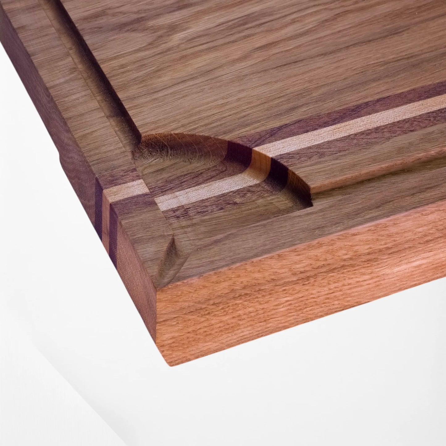 Close-up of wooden chopping board with a visible grain pattern on a white background