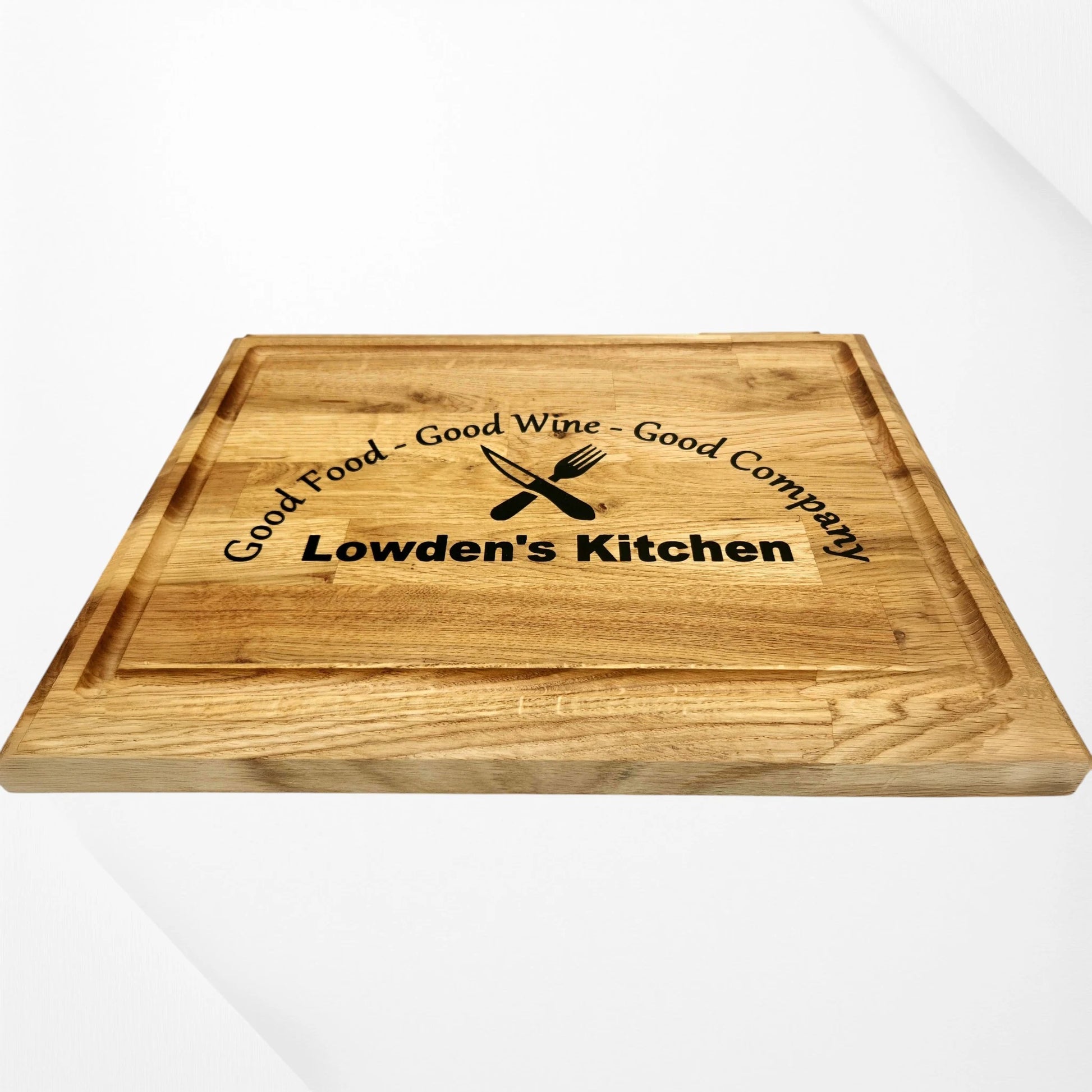 “Personalised oak chopping board engraved with the phrase ‘Good Food – Good Wine – Good Company’ and custom name ‘Lowden’s Kitchen,’ displayed on a white background