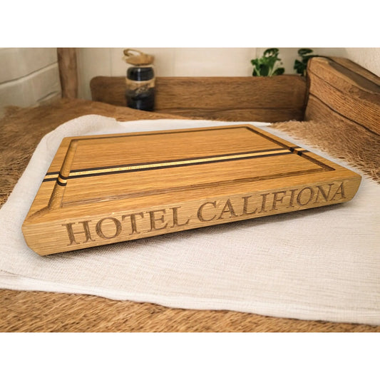Oak Wooden chopping board with 'HOTEL CALIFIONA' engraving on a wooden surface. Optional walnut and maple accent pieces to add a unique feature to the board