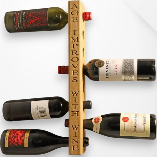 Wall-mounted oak wine rack holding eight bottles, handmade from solid wood, displayed on a white wall in a modern kitchen.