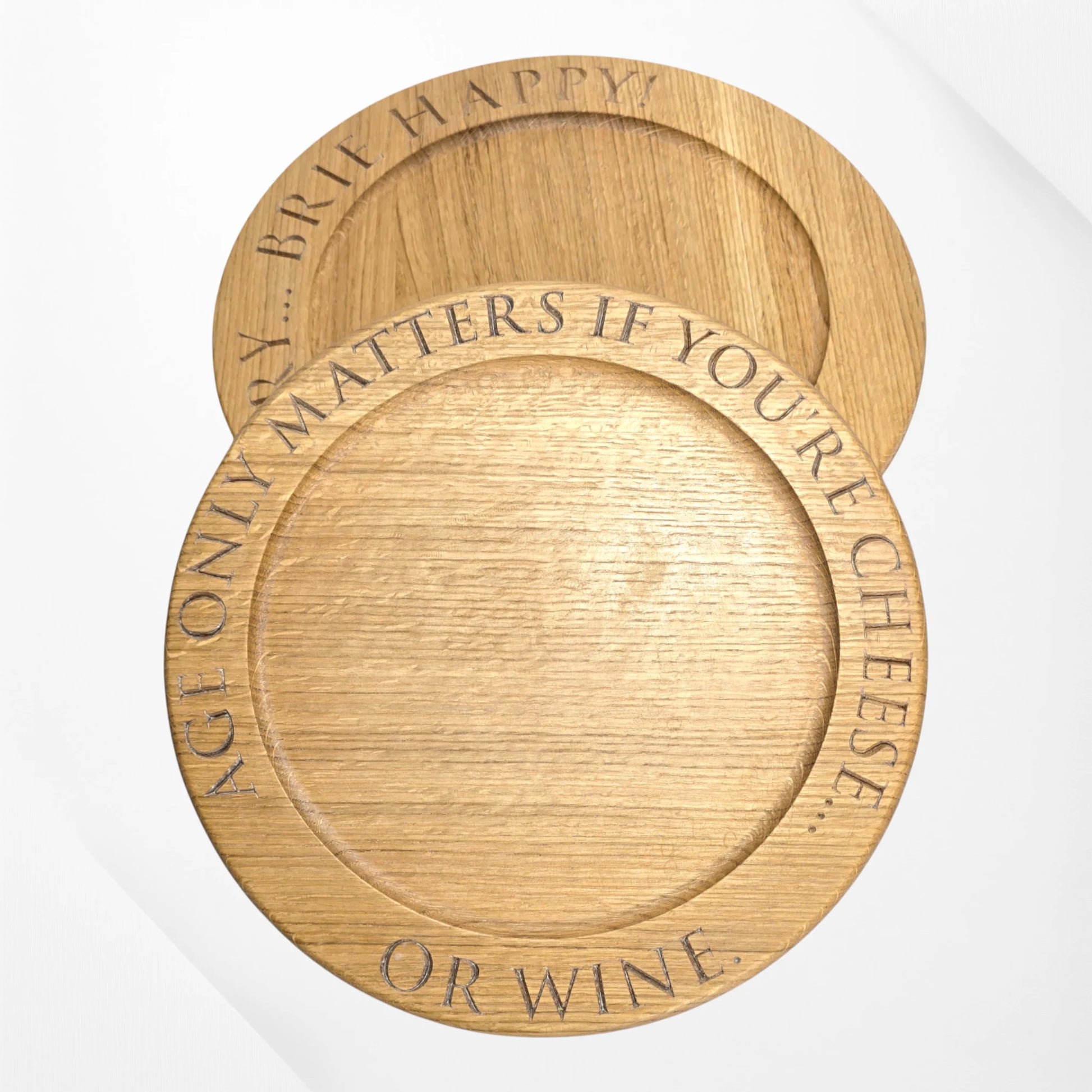Set of engraved oak cheese boards with quotes ‘Age only matters if you’re cheese or wine’ and ‘Brie happy’ – handmade solid oak serving boards by The Crafty Oak