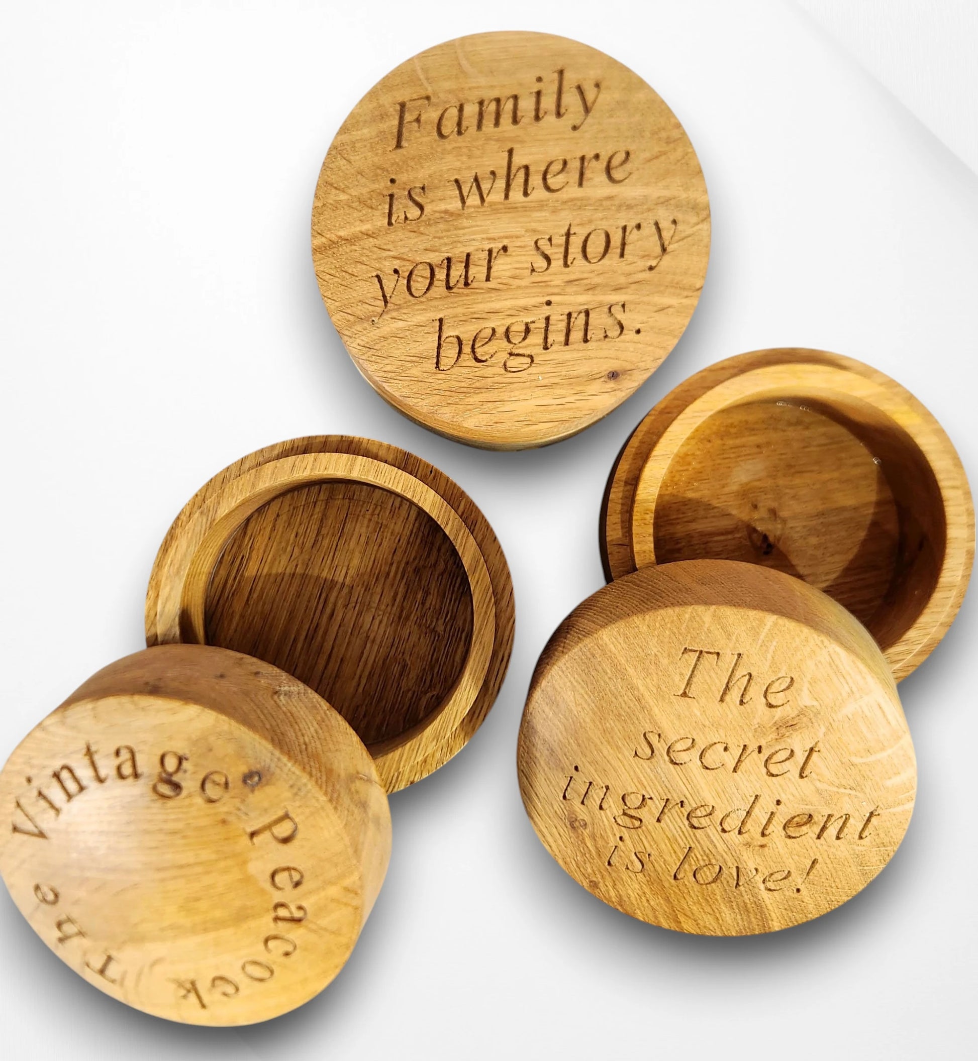 Set of handcrafted round oak trinket boxes engraved with heartfelt quotes — “Family is where your story begins” and “The secret ingredient is love,” perfect personalised wooden keepsake gifts for home or family occasions.