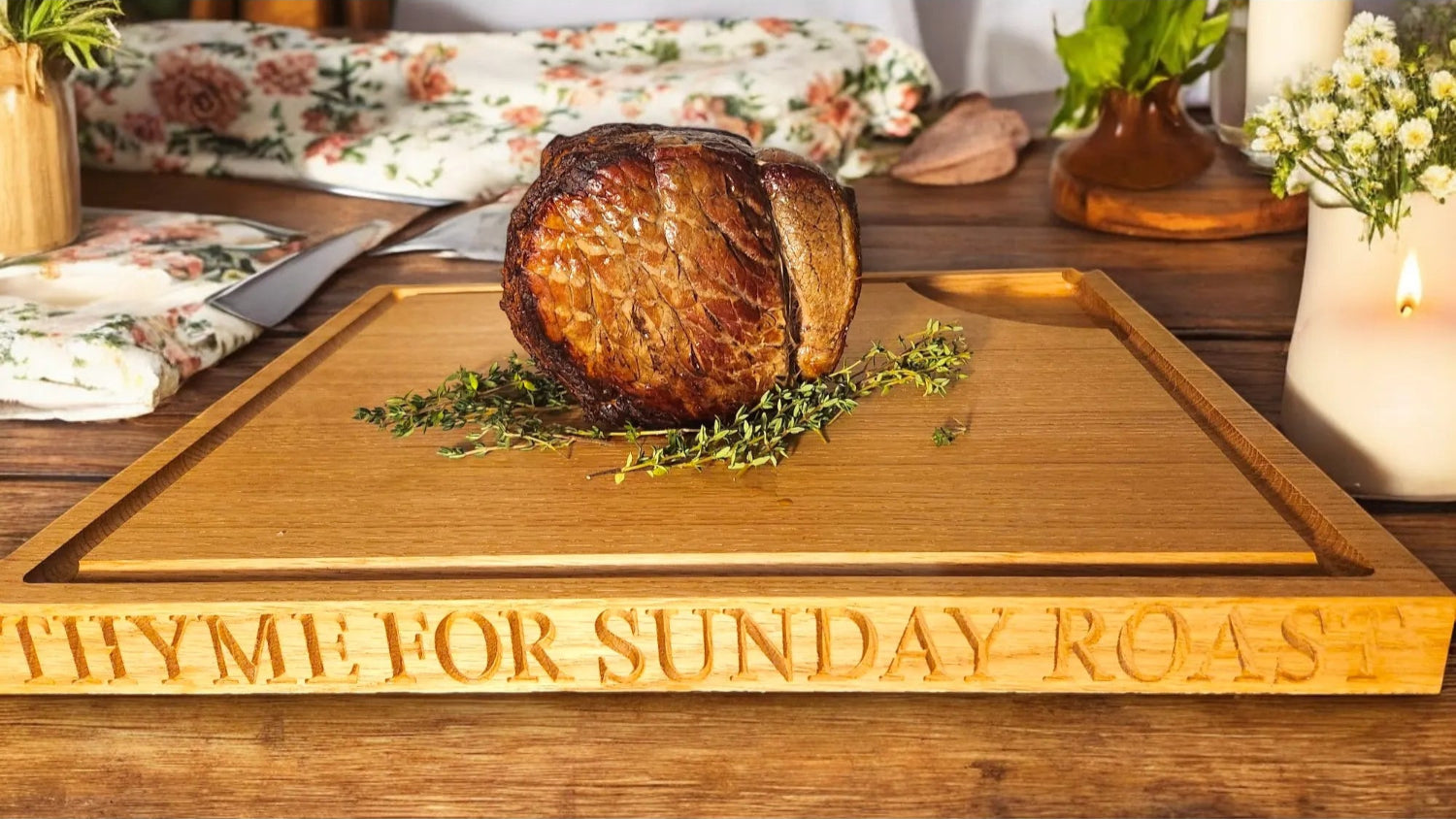 Personalised oak carving board engraved with “THYME FOR SUNDAY ROAST,” serving roast beef and fresh thyme. Handmade chopping board by The Crafty Oak.