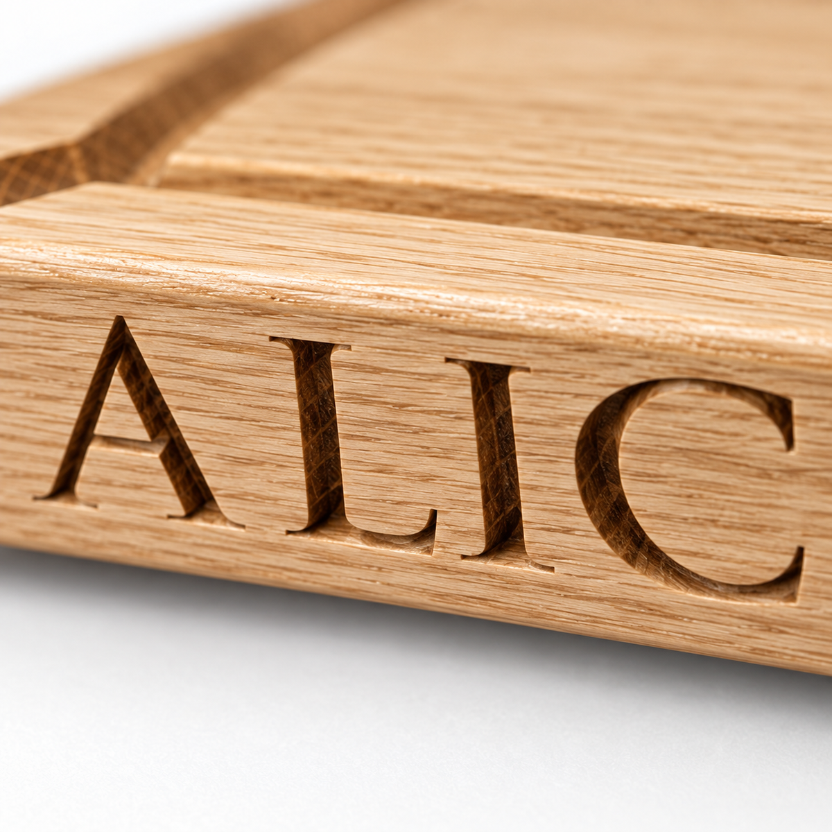 Close-up of deep engraved lettering on a personalised solid oak chopping board