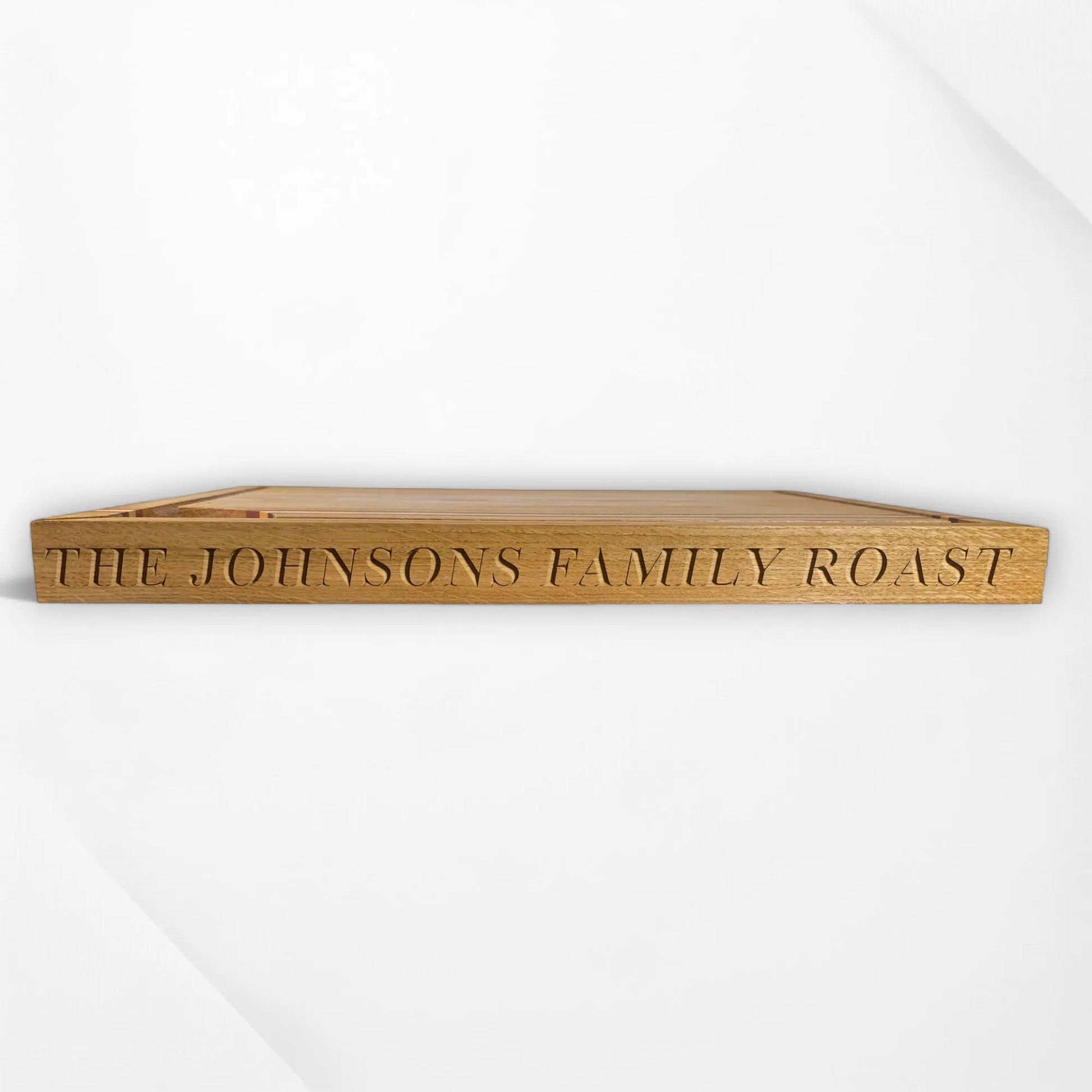 Wooden tray with 'The Johnsons Family Roast' engraving on a white background