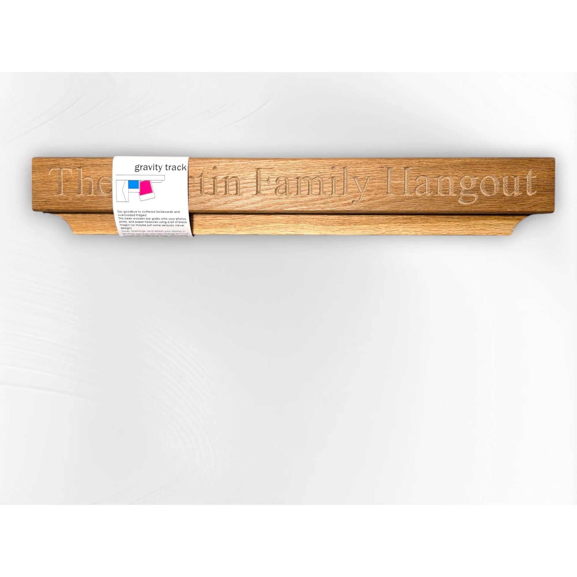 Personalised oak Gravity Track with “The Martin Family Hangout” engraved, shown with product label. Custom wooden photo and paper holder, handmade by The Crafty Oak.