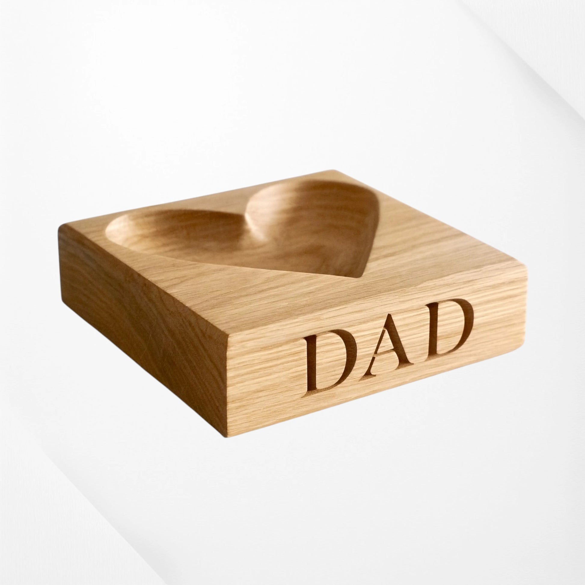 Personalised heart-shaped oak bowl with “DAD” engraving, handmade wooden keepsake dish on a plain white background—ideal Father’s Day, birthday, or memory gift for dad
