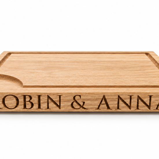Personalised solid oak carving board rotating to show engraved names on both sides