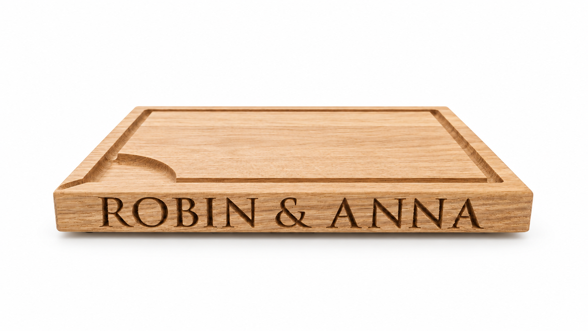 Personalised solid oak carving board rotating to show engraved names on both sides