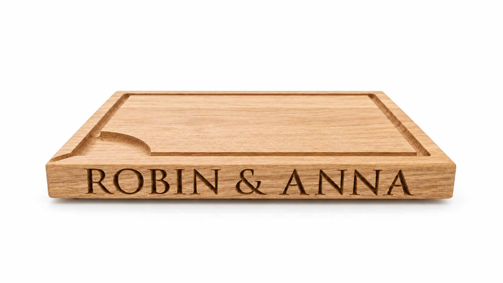 Personalised solid oak carving board rotating to show engraved names on both sides
