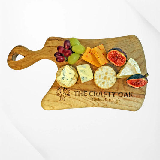 Handcrafted cheese board from The Crafty Oak, engraved and made from premium hardwood. Perfect for serving cheese, crackers, grapes, and figs at any gathering. Elevate your entertaining with artisan quality and elegant personalised details.